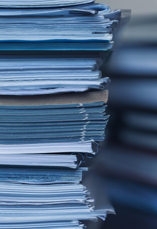 Accounting and taxes. Large pile of magazine and books closeup